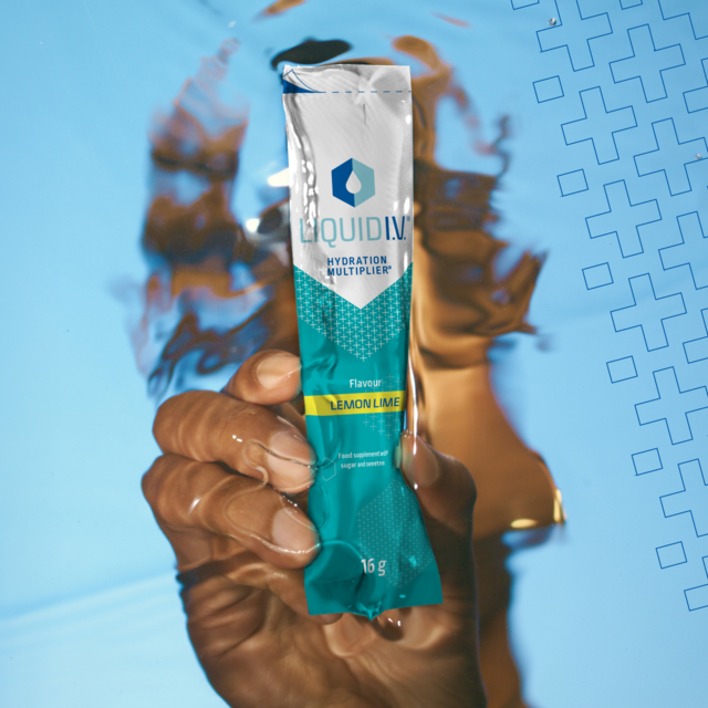 Liquid IV Eletrolyte Powder sachet is being held under water 
